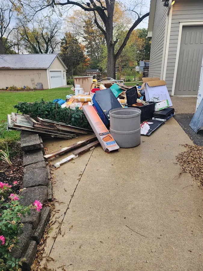 Dumpster being loaded with debris for 10 Yard Dumpster Rental in Blackwell